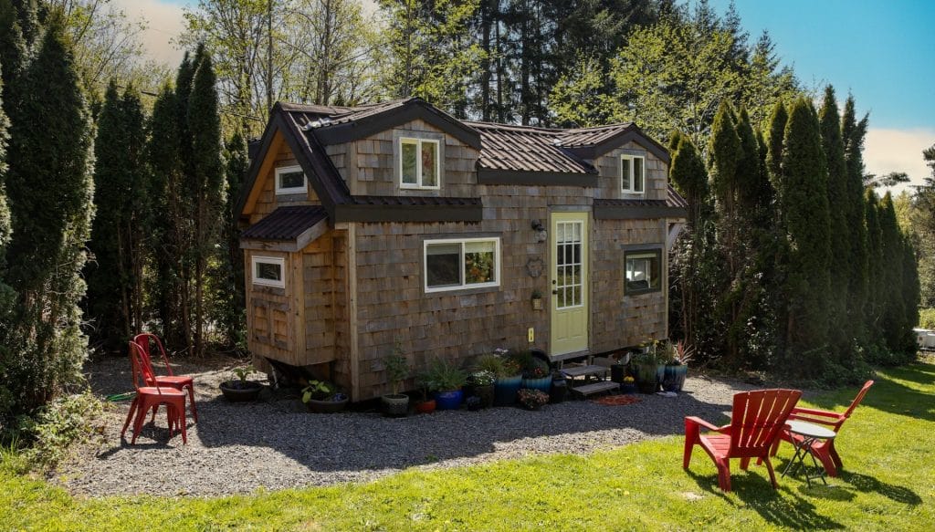 Cute little tiny home with wood paneling and privacy for a minimalist living experience